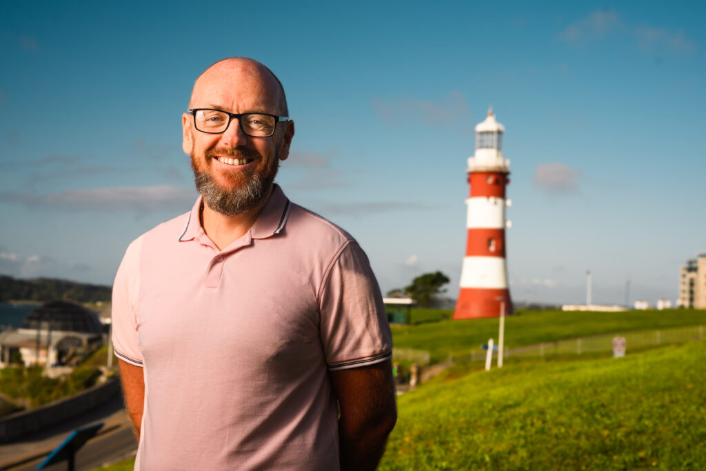 David Johns standing outside Smeatons Tower lighthouse